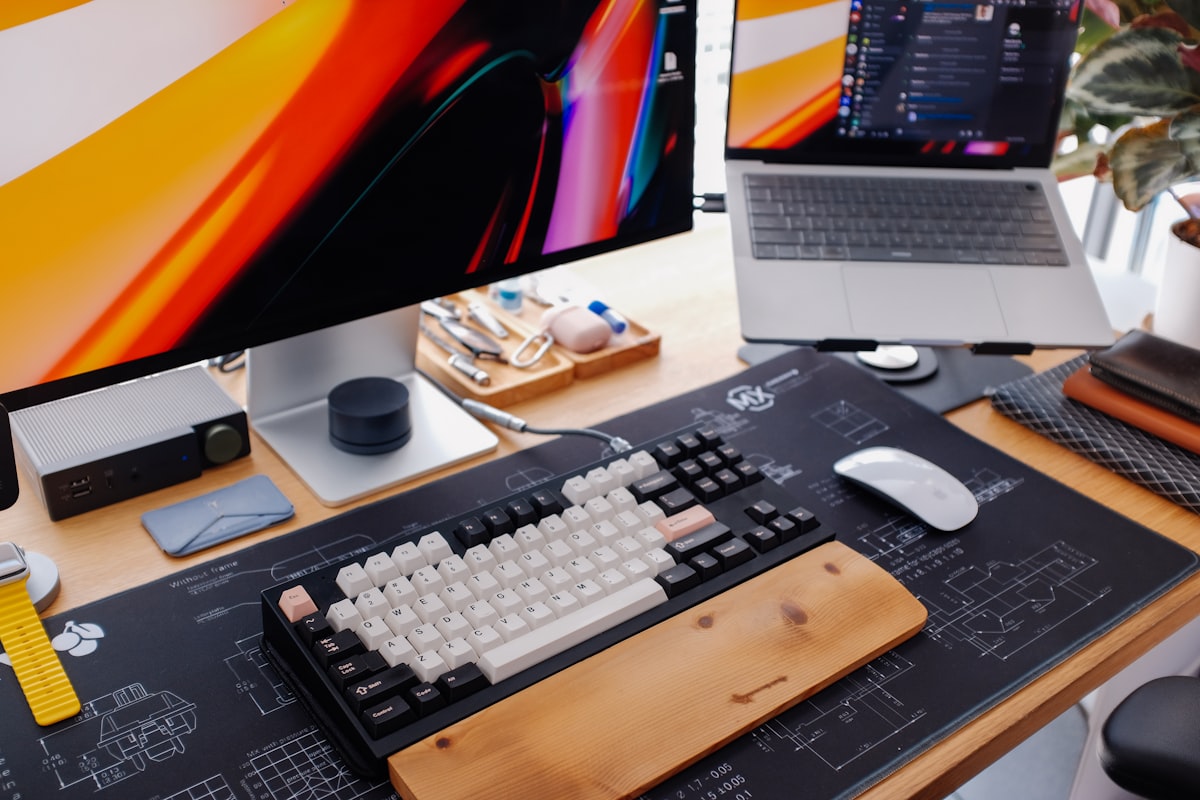 Modern clean desk workspace with keyboard, monitor, and office equipment