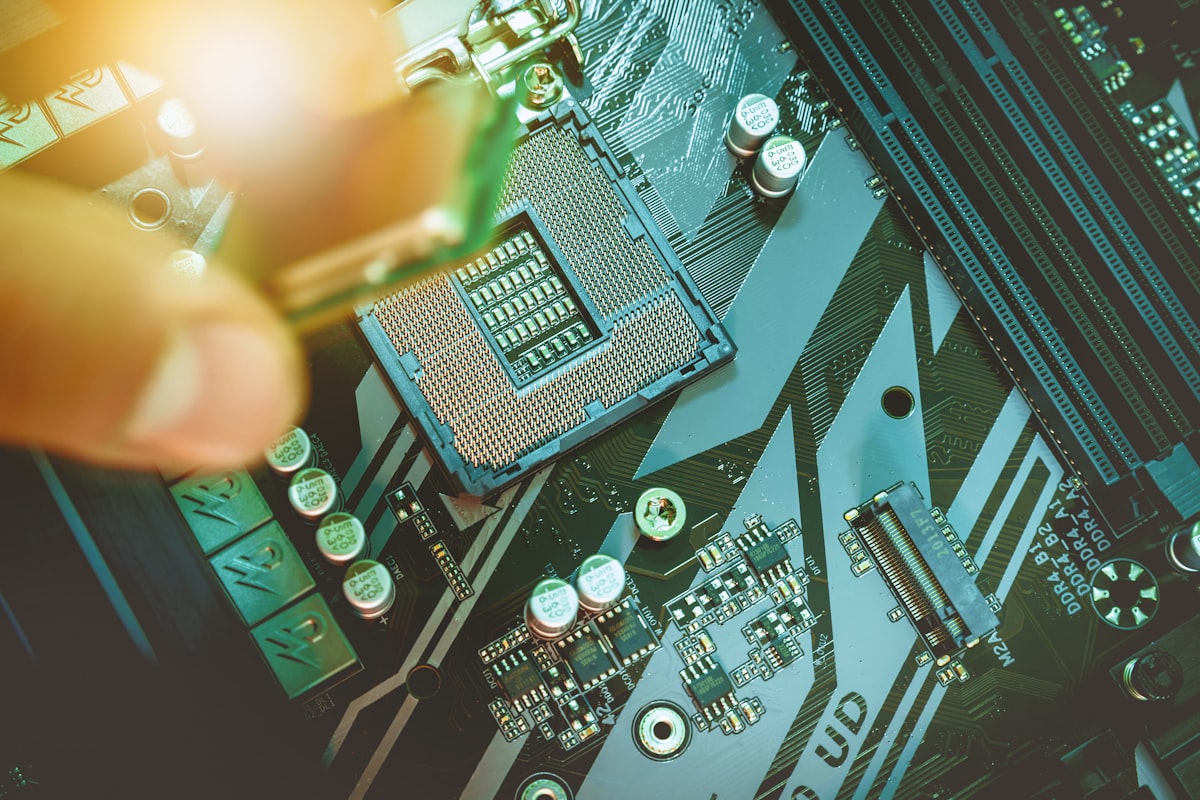 Hands installing a CPU processor chip onto a motherboard socket